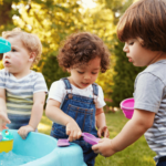 Kids playing with a water table as part of an occupational therapy activity for tactile defensiveness.